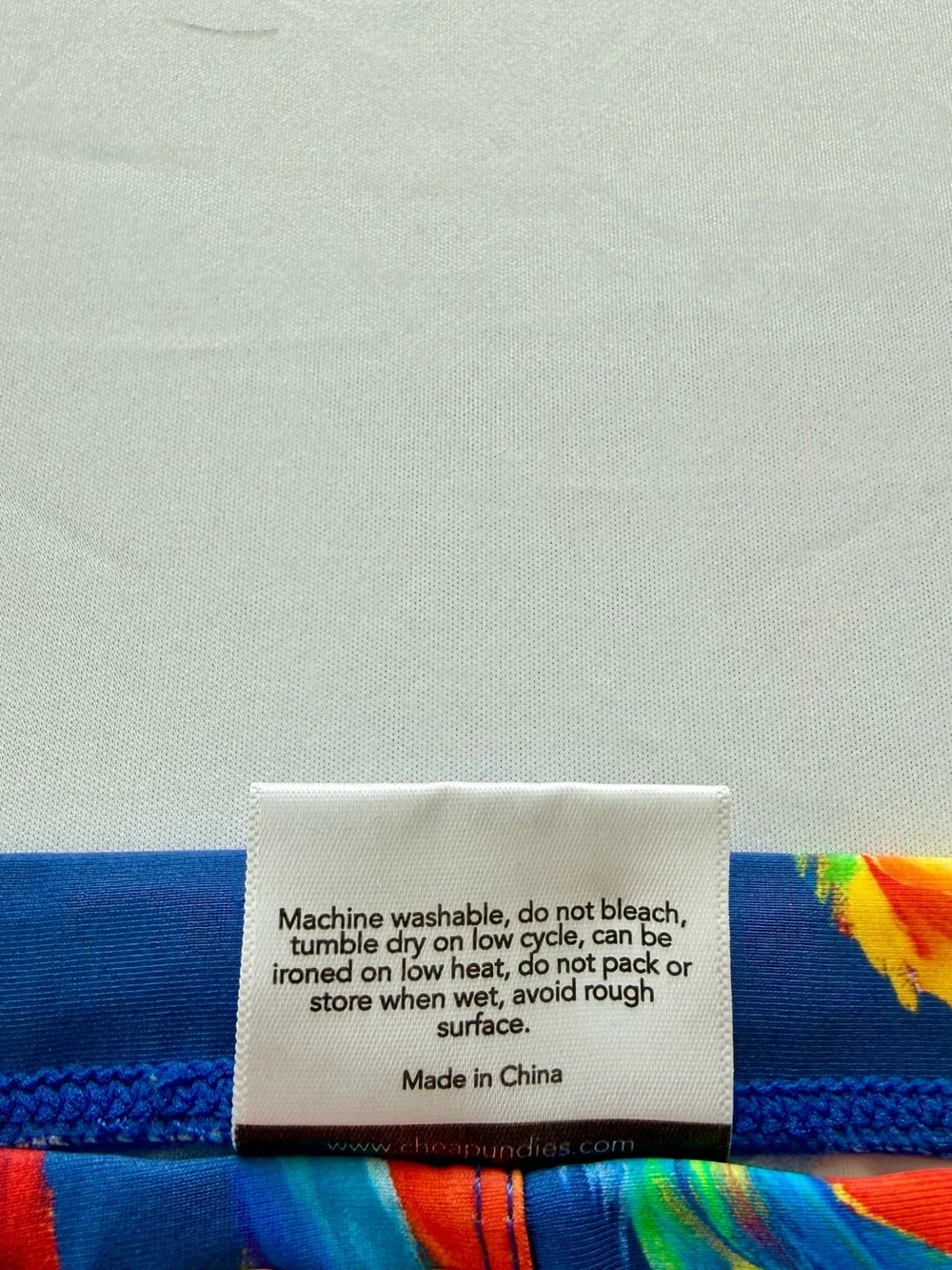 Men's Navy Swim Briefs with Colorful Parrot Print
